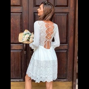 White, lace back dress with bell sleeves. Backless.